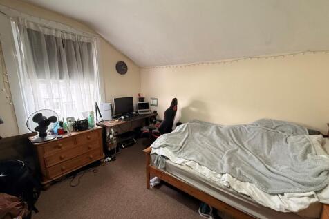 Bright attic double bedroom with a large window...