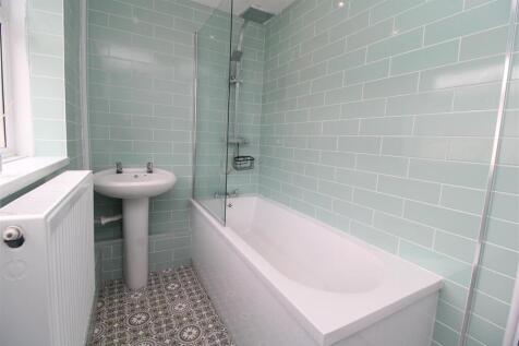 Modern bathroom with stylish tiles and bathtub....