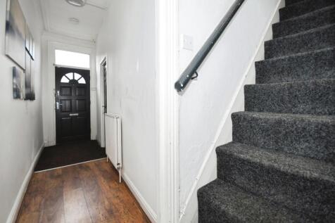 Bright entry hallway with classic wood flooring...