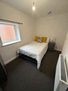 Bright, neatly presented bedroom with a comfort...