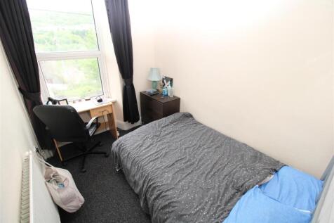 Bright bedroom with large window and study desk...