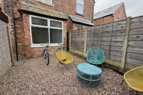 Private gravel courtyard with colourful outdoor...