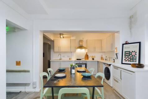 Bright, modern open-plan kitchen and dining are...
