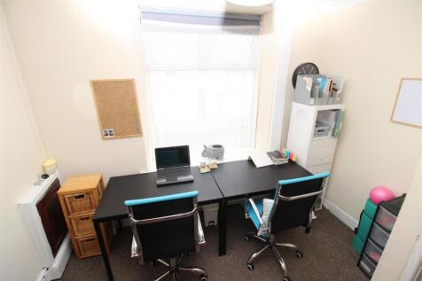 Bright home office with two desks and natural l...