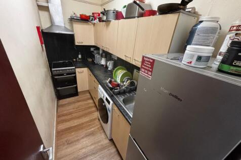 Compact galley kitchen with fitted base and wal...