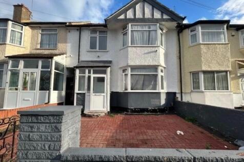 Terraced front exterior with paved driveway and...