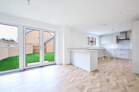 The timeless kitchen is a generous size with feature flooring