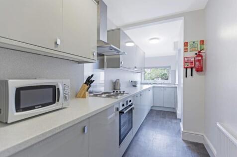 A modern and tidy kitchenette featuring ample s...