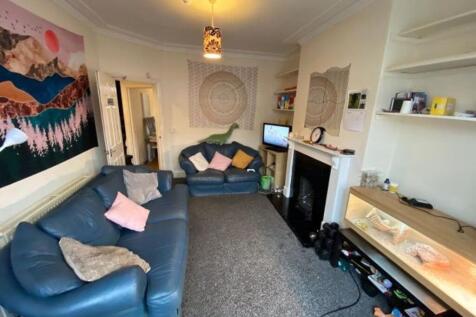 Bright, comfortable living room with two blue s...