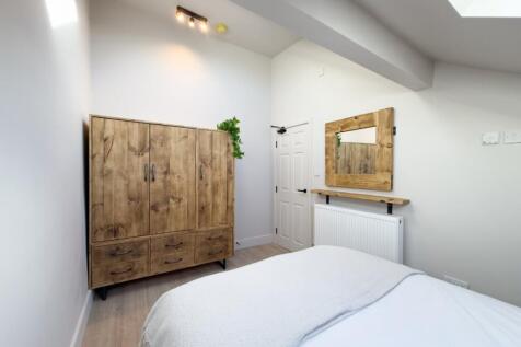 Bright, neatly presented bedroom with a comfort...