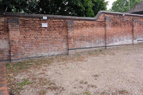 Spacious outdoor area with classic brick walls...
