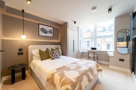 Modern bright bedroom with study window desk...
