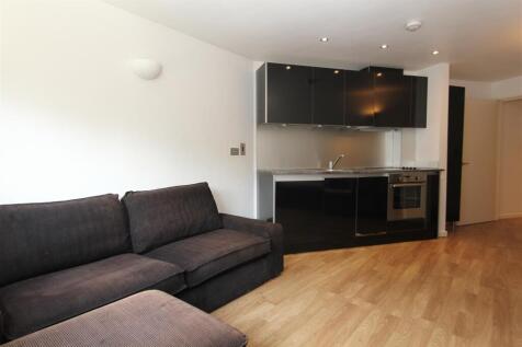 Modern living area with sleek integrated kitche...