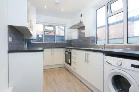 Bright and modern kitchen featuring ample count...