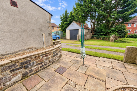 Sunlit Courtyard with Folded Clothesline.png