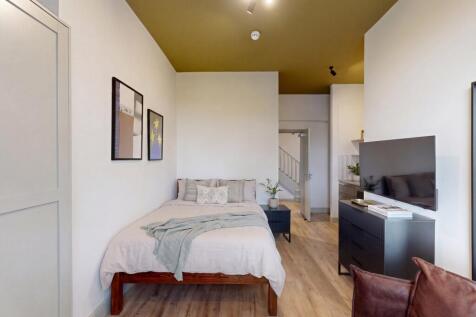 Stylish modern bedroom with high feature ceilin...
