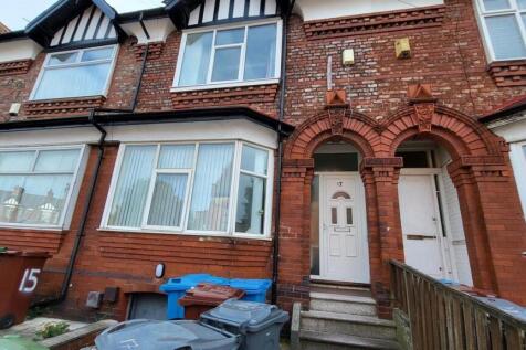 Red-brick terraced house with bay window and ar...