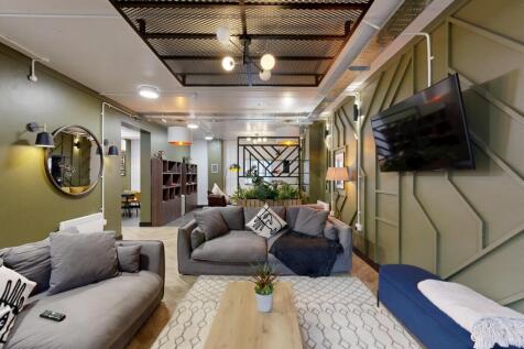 Contemporary, cosy living room with plush sofas...