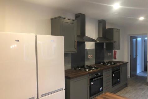 Modern shared kitchen with twin ovens and gas h...