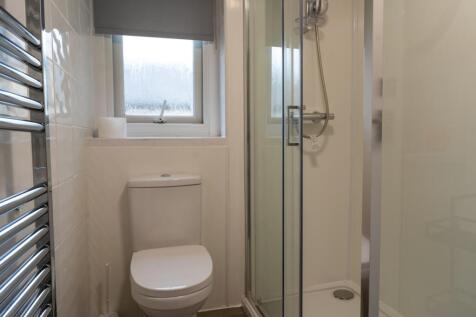 A modern and tidy bathroom featuring a sleek sh...