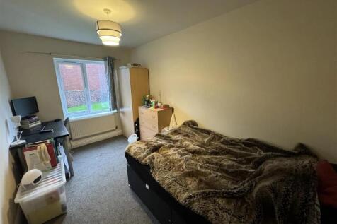 A comfortable bedroom featuring a large double ...