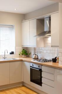 Bright modern kitchen with wood-effect worktops...