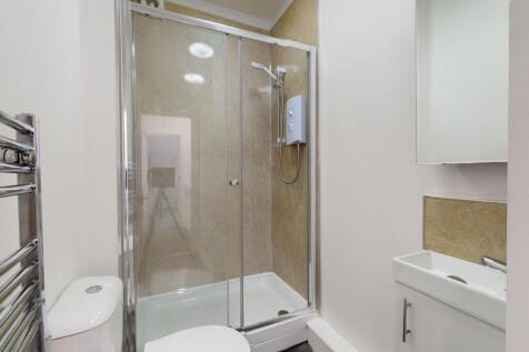 Modern compact bathroom with a walk-in shower i...