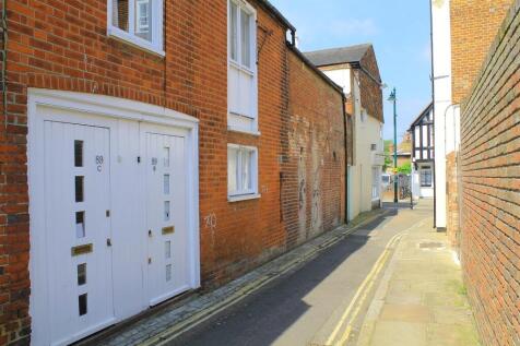 Quiet narrow street with brick-fronted property...