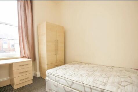 Bright, simply furnished single bedroom with a ...