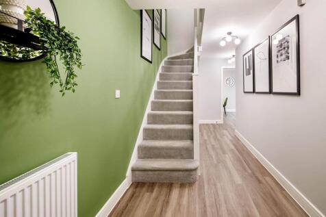 Spacious hall with handy under stairs storage cupboard