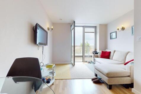 Bright lounge with balcony access and large sof...