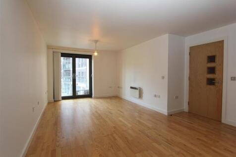 Bright lounge with sleek wooden flooring...