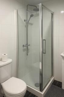 Modern tiled bathroom with a framed glass showe...