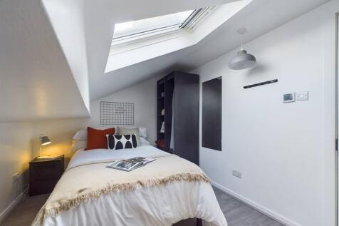 Bright, neatly presented bedroom with a comfort...