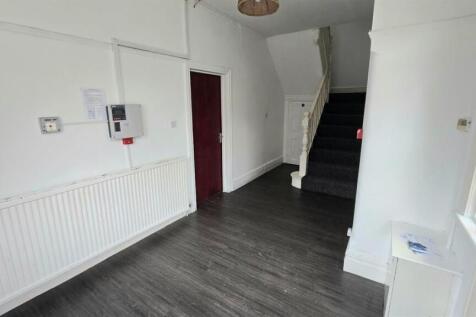 Spacious hallway with modern wood-effect floori...