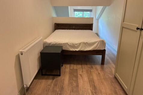 Bright double bedroom with modern wood flooring...