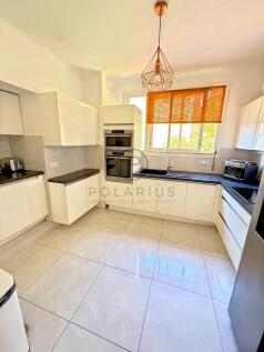 Bright and modern kitchen with white cabinetry, bl