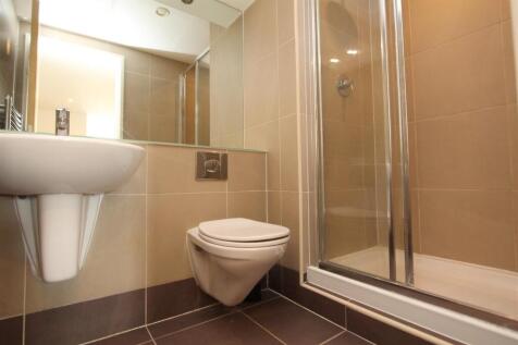 Modern tiled bathroom with sleek glass shower....