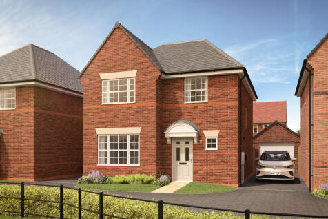 A red brick house with a white door and garage sits behind a black metal fence