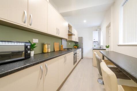 Bright and modern kitchen with ample cupboard s...