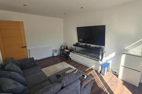 Modern living room with large TV and comfy sofa...