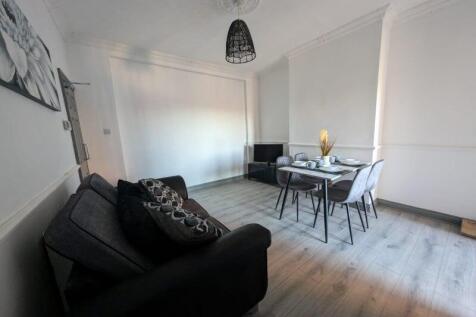 Bright, modern living room with wood-effect flo...