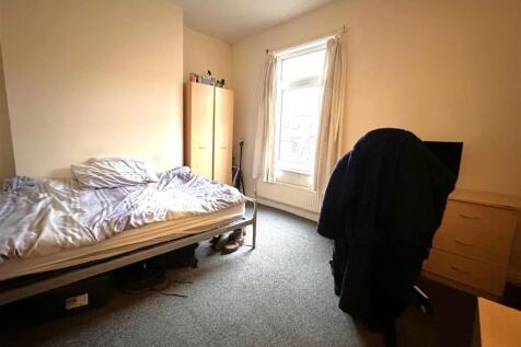 Bright, simply furnished single bedroom with a ...
