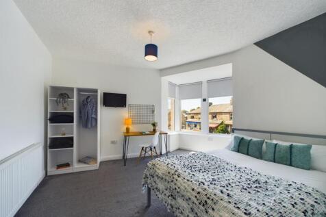 A bright and tidy living room featuring a large...