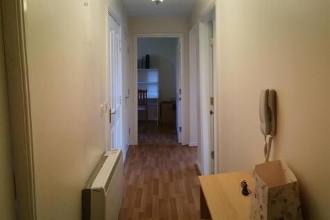 Bright, neutral hallway with wood-effect floori...