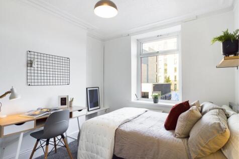 A bright and inviting double bedroom with a coz...