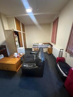 Spacious studio-style room with a comfortable l...