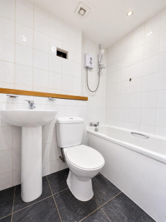 Bright Minimalist White-Tiled Bathroom (1).png