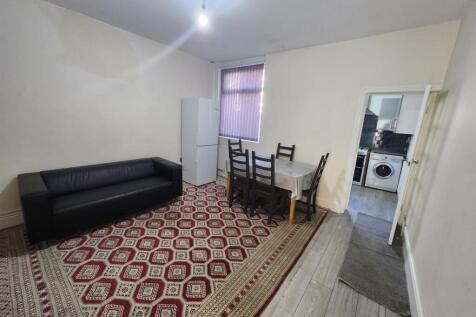 Bright living room with a patterned area rug, b...
