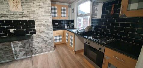 Bright kitchen with stylish dark subway tiles...
